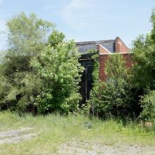 Old roundhouse surrounded by trees.